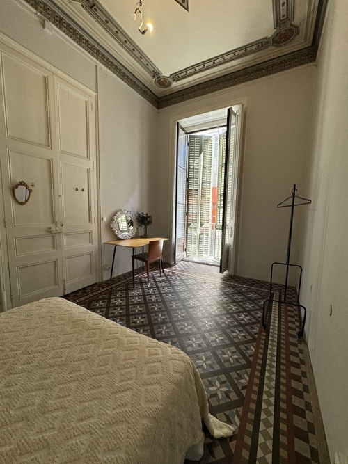 Spacious bedroom with balcony in a very large house